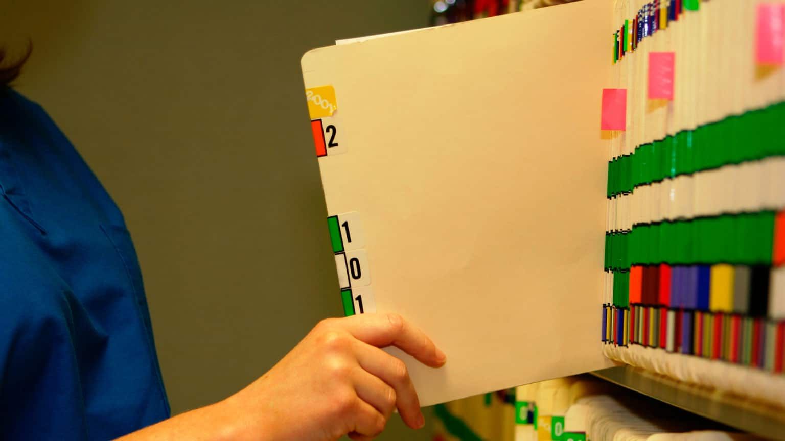 medical official pulling out chart from an organizer