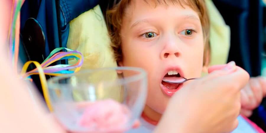 child being fed with spoon