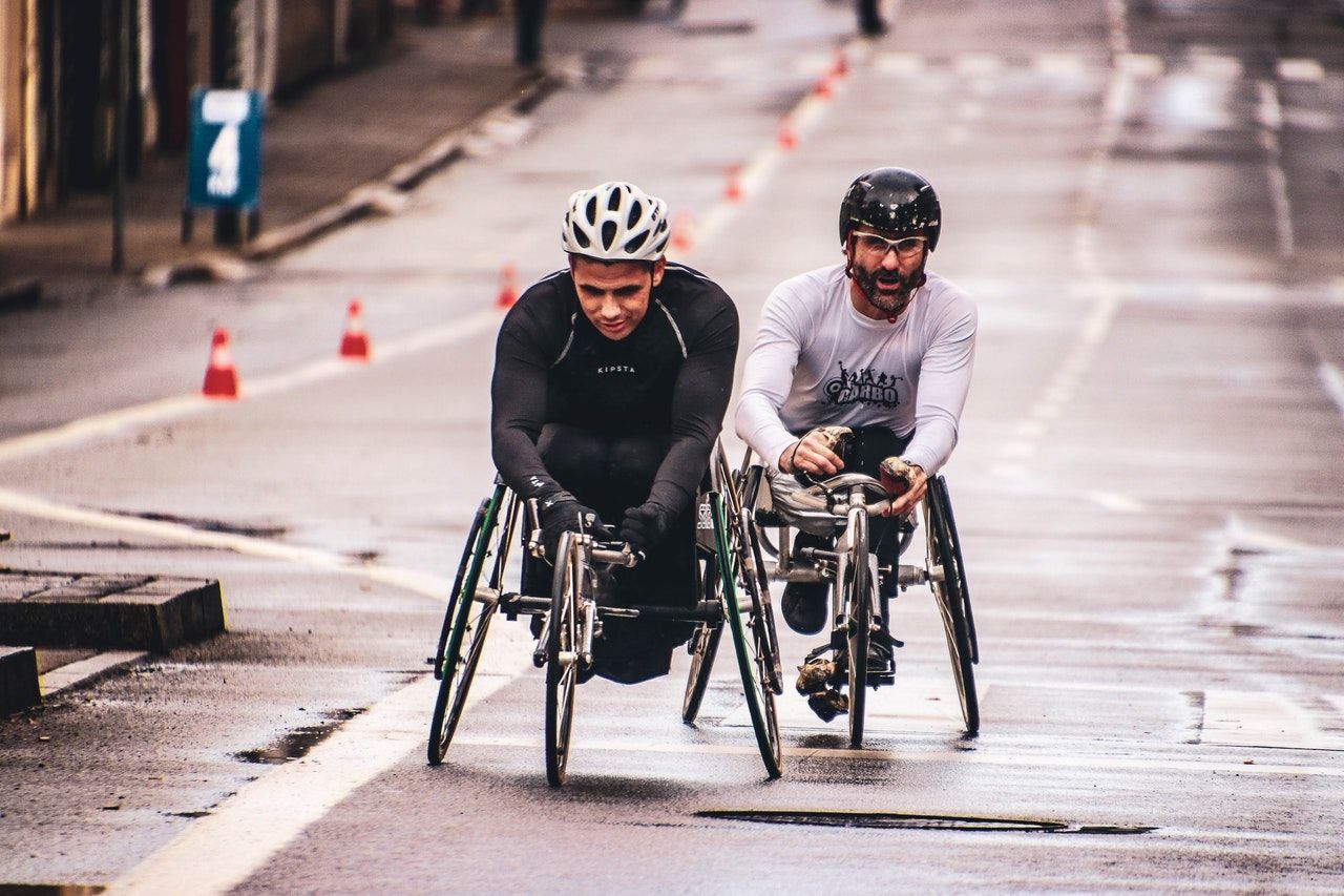 dos hombres que utilizan bicicletas adaptadas para minusválidos tras sufrir lesiones laborales.